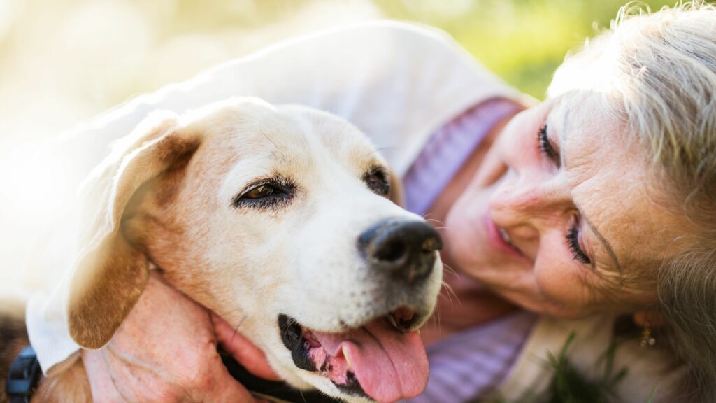 Woman snuggling dog